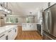 Open kitchen layout featuring a large island, stainless steel appliances, and wood floors at 106 Governor Boone Ln., Georgetown, SC 29440