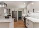 Well-lit kitchen with stainless steel appliances, white cabinets, and subway tile backsplash at 106 Governor Boone Ln., Georgetown, SC 29440