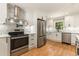 Bright kitchen with white cabinets, stainless steel appliances, and modern tile backsplash at 106 Governor Boone Ln., Georgetown, SC 29440