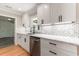 Renovated kitchen featuring quartz countertops, a stainless steel dishwasher, and updated cabinets at 106 Governor Boone Ln., Georgetown, SC 29440