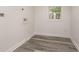 Laundry room with wood-look floors and window at 106 Governor Boone Ln., Georgetown, SC 29440