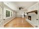 Bright open-concept living room with a cozy fireplace, hardwood floors, and views to the chef's kitchen at 106 Governor Boone Ln., Georgetown, SC 29440