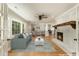 Bright open-concept living room with a cozy fireplace, hardwood floors, and views to the chef's kitchen at 106 Governor Boone Ln., Georgetown, SC 29440