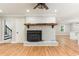Spacious living room with a painted brick fireplace and hardwood floors at 106 Governor Boone Ln., Georgetown, SC 29440