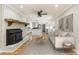 Staged living room features hardwood floors, fireplace, and an open view to the modern kitchen at 106 Governor Boone Ln., Georgetown, SC 29440