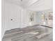 Bright sunroom with a white door, light grey wood floors, and a view of the garden at 106 Governor Boone Ln., Georgetown, SC 29440
