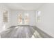 Sunroom with white walls, grey floors, glass paneled double doors, and bright natural light at 106 Governor Boone Ln., Georgetown, SC 29440