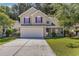 Two-story house with beige siding, attached garage, and manicured lawn at 1247 Brighton Ave., Myrtle Beach, SC 29588