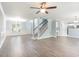 Bright living room with hardwood floors, fireplace, and open staircase at 1247 Brighton Ave., Myrtle Beach, SC 29588