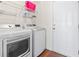 Bright laundry room features washer, dryer, and ample shelving at 1704 Riverport Dr., Conway, SC 29526