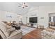 Relaxing living room with hardwood floors, fireplace, and large TV at 1704 Riverport Dr., Conway, SC 29526