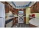 Kitchen with wood cabinets, white appliances, and breakfast bar at 1801 N Ocean Blvd. # K1, North Myrtle Beach, SC 29582
