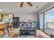 Living room with hardwood floors, gray sofa and a view of the balcony at 1881 Colony Dr. # 7D, Surfside Beach, SC 29575