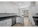 Modern kitchen with white cabinets, granite countertops, and stainless steel appliances at 2307 Blackbird Ct., Murrells Inlet, SC 29576