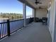 Spacious covered balcony with black metal railings and seating, overlooking a lake at 257 Venice Way # H 204, Myrtle Beach, SC 29577