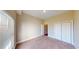 Bright bedroom featuring neutral walls, carpet flooring, and a large window with blinds at 257 Venice Way # H 204, Myrtle Beach, SC 29577