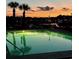 Community pool lit at night, surrounded by lounge chairs and palm trees overlooking the waterfront at 257 Venice Way # H 204, Myrtle Beach, SC 29577
