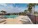 A community pool during the day, with lounge chairs and palm trees overlooking a body of water at 257 Venice Way # H 204, Myrtle Beach, SC 29577