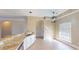 Modern kitchen with granite counters, stainless appliances, tiled floor, modern lighting, and a breakfast bar at 257 Venice Way # H 204, Myrtle Beach, SC 29577