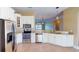 Bright kitchen showcasing stainless steel appliances, granite countertops, and a breakfast bar with views of the living space at 257 Venice Way # H 204, Myrtle Beach, SC 29577