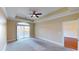 Spacious main bedroom with tray ceiling, a ceiling fan, large window and an adjacent bathroom at 257 Venice Way # H 204, Myrtle Beach, SC 29577