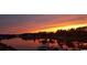 Scenic lake view at sunset featuring a dock and a beautiful, colorful sky at 257 Venice Way # H 204, Myrtle Beach, SC 29577