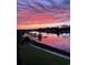 Serene sunset water view featuring docks and boat slips, as well as a beautiful pink sky at 257 Venice Way # H 204, Myrtle Beach, SC 29577