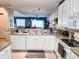 Kitchen features double sinks, white cabinets, and view to dining area at 270 Connemara Dr. # C, Myrtle Beach, SC 29579