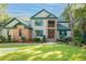 Two story home with brick and stucco exterior, green accents, and landscaped yard at 270 Widgeon Dr., Pawleys Island, SC 29585