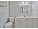 Modern bathroom with white vanity and a large mirror at 4850 Meadowsweet Dr. # 1711, Myrtle Beach, SC 29579