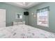 Bedroom with queen bed, dresser, and window view at 4872 Dahila Ct. # 301, Myrtle Beach, SC 29577