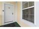 Condo building entry with white door and window, showing keyless entry at 4872 Dahila Ct. # 301, Myrtle Beach, SC 29577