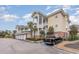 Exterior of 3-story condo building with parking and landscaping at 4872 Dahila Ct. # 301, Myrtle Beach, SC 29577