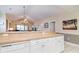 Kitchen with white cabinets, granite countertops, and views into living area at 4872 Dahila Ct. # 301, Myrtle Beach, SC 29577