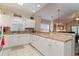 Open kitchen features white cabinets, granite countertops, and a breakfast bar at 4872 Dahila Ct. # 301, Myrtle Beach, SC 29577