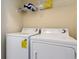 Well-lit laundry room with washer and dryer and overhead shelving at 4872 Dahila Ct. # 301, Myrtle Beach, SC 29577