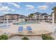 Community pool with lounge chairs and surrounding patio at 4872 Dahila Ct. # 301, Myrtle Beach, SC 29577