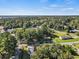 An aerial view of a residential area featuring several houses and a church in a tranquil suburban setting at 505 Alston St., Conway, SC 29526