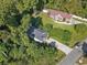 Aerial view of two houses, one with a red roof and another with a gray roof, situated on a tree-lined lot at 505 Alston St., Conway, SC 29526