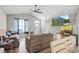 Spacious living room featuring hardwood floors, a ceiling fan, and ample natural light at 505 Alston St., Conway, SC 29526