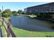 Serene pond with fountain, landscaping, and building in background at 5905 S Kings Highway # 2106-C, Myrtle Beach, SC 29575