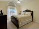 Bedroom with large window, ceiling fan, and ensuite bath at 635 Bucks Trail, Longs, SC 29568