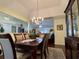 Bright dining room with chandelier and view into living area at 635 Bucks Trail, Longs, SC 29568