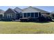 Brick ranch house with screened porch and landscaped yard at 635 Bucks Trail, Longs, SC 29568