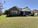 Brick ranch house with screened porch and landscaped yard at 635 Bucks Trail, Longs, SC 29568