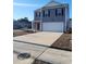 Two-story house with gray siding, red door, and attached garage at 6605 Colonial Dr., Myrtle Beach, SC 29572