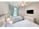 Bright bedroom with twin beds, dresser, and large TV at 663 Pinehurst Dr. # 93C, Pawleys Island, SC 29585