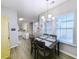 Charming dining area with table and four chairs, near the kitchen at 663 Pinehurst Dr. # 93C, Pawleys Island, SC 29585