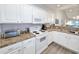 Bright kitchen with white cabinets, granite countertops, and stainless steel appliances at 663 Pinehurst Dr. # 93C, Pawleys Island, SC 29585