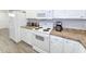 White kitchen cabinets, stainless steel appliances, and granite countertops at 663 Pinehurst Dr. # 93C, Pawleys Island, SC 29585